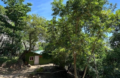 Mannarkkad Apartment | A room with a king-size bed and a view of the mountains