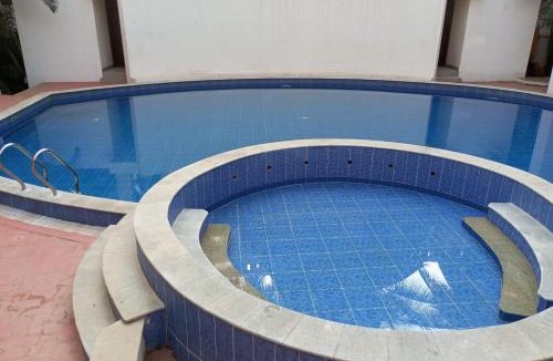 Bengaluru House | Amazistay offers Luxury room with private bathroom, balcony & 55 inch TV & shared Jacuzzi paid access, Book Lover, near Ramaiah College Hospital