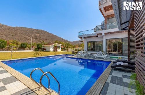 Bedla Villa | StayVista's Bella Dream - Mountain-View with Outdoor Pool, Lawn featuring a Gazebo & Indoor Games