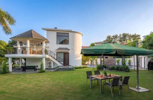 Ludhiana Villa | StayVista's The Secret Lagoon with Outdoor Pool, Verdant Lawn & Indoor-Outdoor Activities