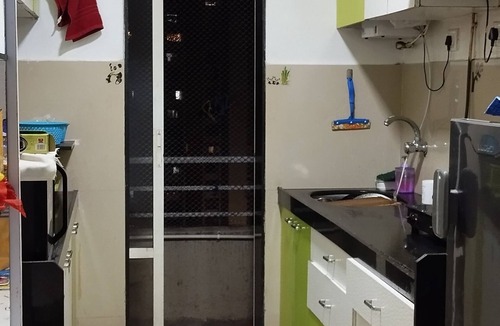 Mira Road East Apartment | The perchnOne cosy room with swimming pool and gym.