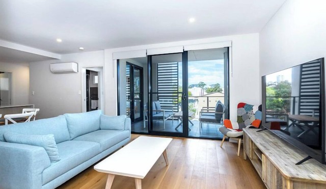 Rooftop Sky Lounge has a daybed, tables and stools, a lounge area with a big screen TV and a grassed in Leederville