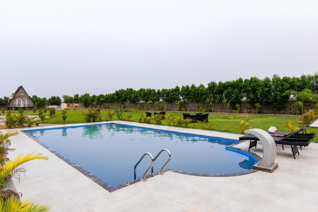 Faridabad Villa | ELIVAAS Signature Malik Farms Countryside Wooden Cottage on 2 Acre Estate with Shared Pool, Garden & Restaurant