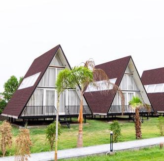 Faridabad Villa | ELIVAAS Signature Malik Farms Countryside Wooden Cottage on 2 Acre Estate with Shared Pool, Garden & Restaurant