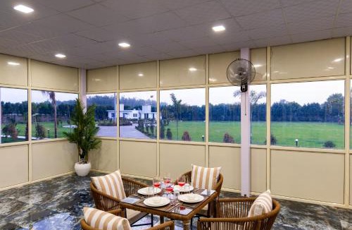 Faridabad Villa | ELIVAAS Signature Malik Farms Countryside Wooden Cottage on 2 Acre Estate with Shared Pool, Garden & Restaurant